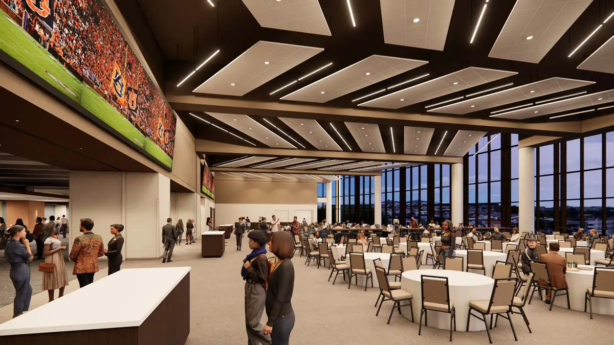 Rendering of the Multipurpose Hall with large video screens, round-table banquet seating, and floor-to-ceiling windows overlooking campus
