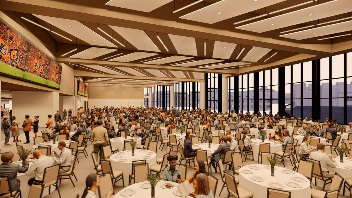 Rendering of the Multipurpose Hall side view with large-screen displays, round-table seating, and floor-to-ceiling windows at dusk