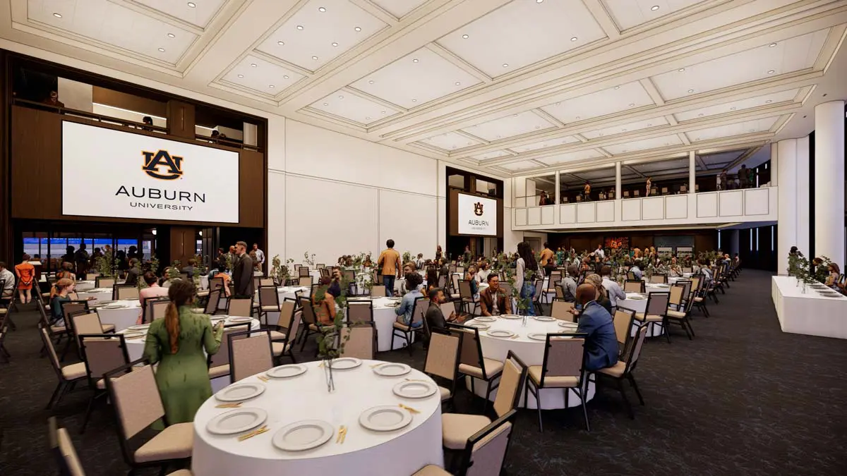 Rendering of the Ballroom from the opposite angle with banquet seating, second-floor balcony, and Auburn screens