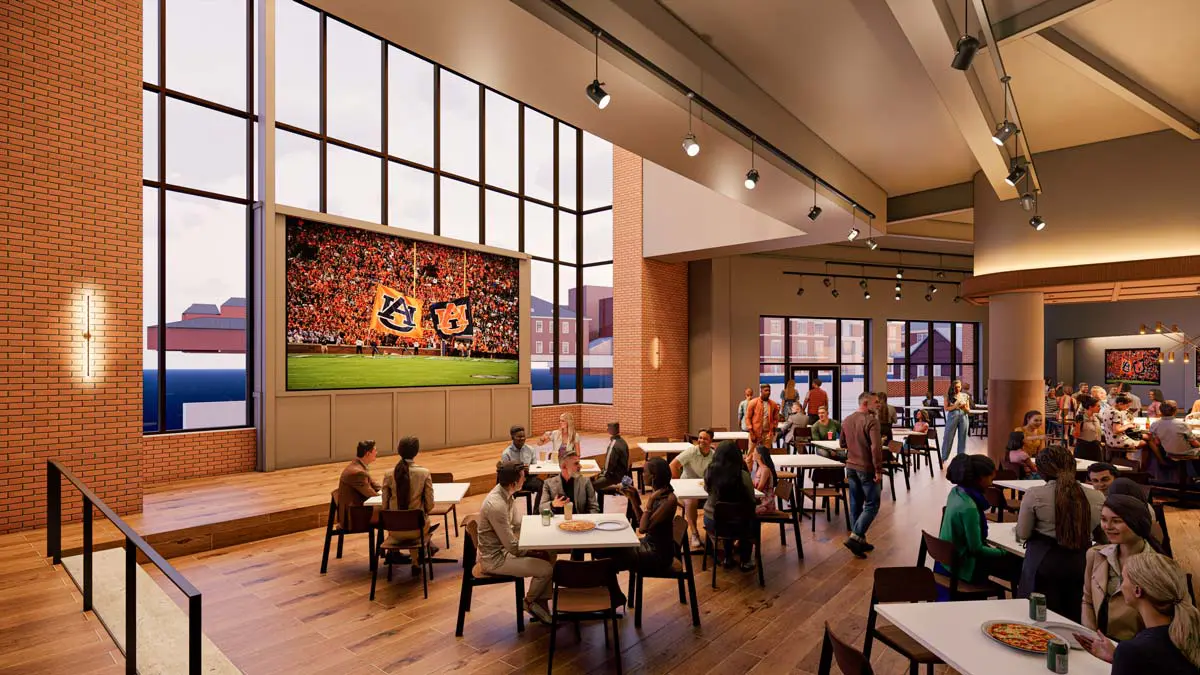 Rendering of Pat's Place lounge with large screen, floor-to-ceiling windows, and table seating