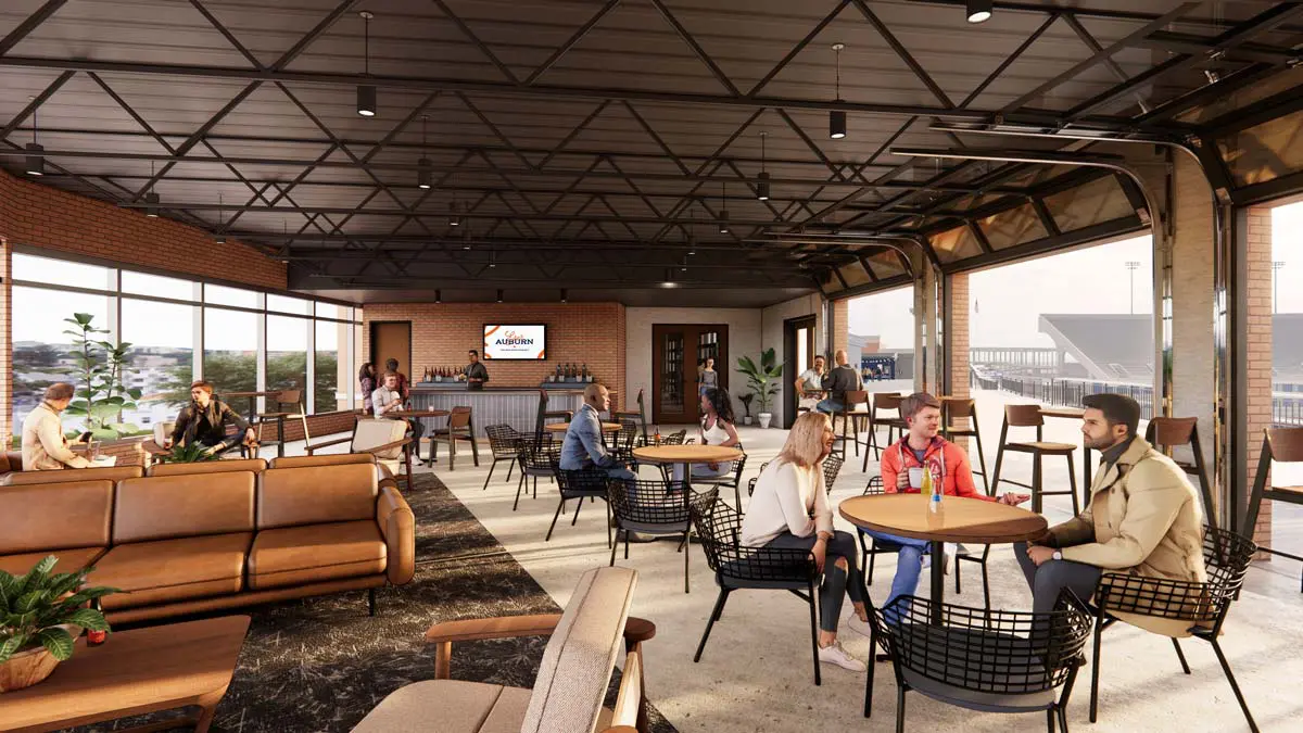 Rendering of Tiger's Terrace indoor lounge with brick walls, bar, and open-air garage doors to the terrace